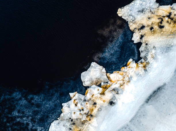 istock Water and ice surface texture. Aerial view from drone during thaw in early spring. Ice melting. Thin ice on the river.  Abstract ice background. 1370420722