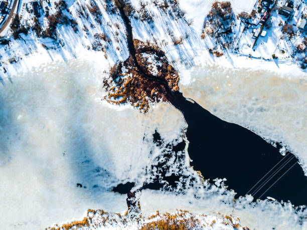istock Water and ice surface texture. Aerial view from drone during thaw in early spring. Ice melting. Thin ice on the river.  Abstract ice background. 1370420730