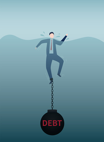 Businessman feet tied with iron balls falling into the water，drowning in debt.