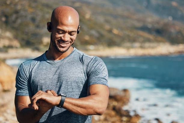 istock Shot of a man using his watch to track his pulse while out for a workout 1370421105