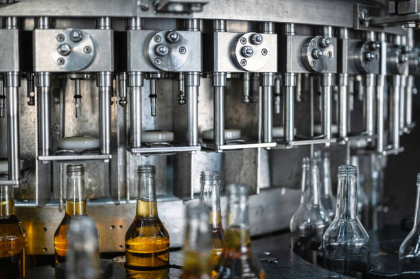 istock Automatic production line fills glass bottles with cognac 1370421889