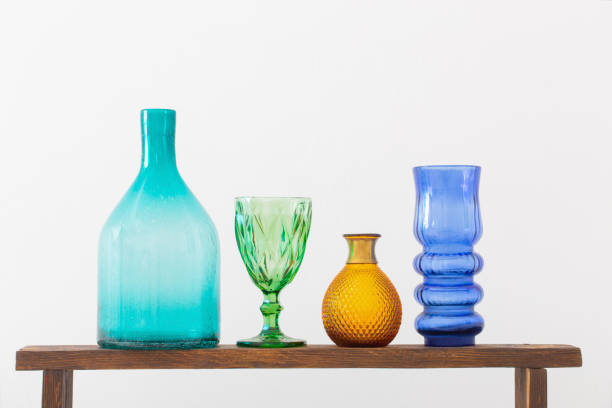 istock glass vases on wooden shelf on white background 1370422205