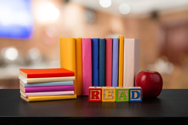 istock Stack of books on wooden table against blurred background 1370425491