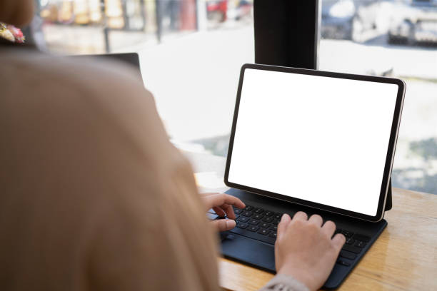 istock Over shoulder view of female freelancer hands typing on wireless keyboard of digital tablet. 1370426310