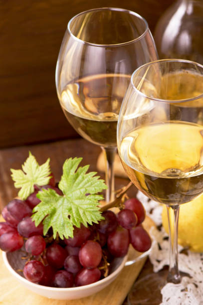 istock Wine and grapes in vintage setting on wooden table 1370427447