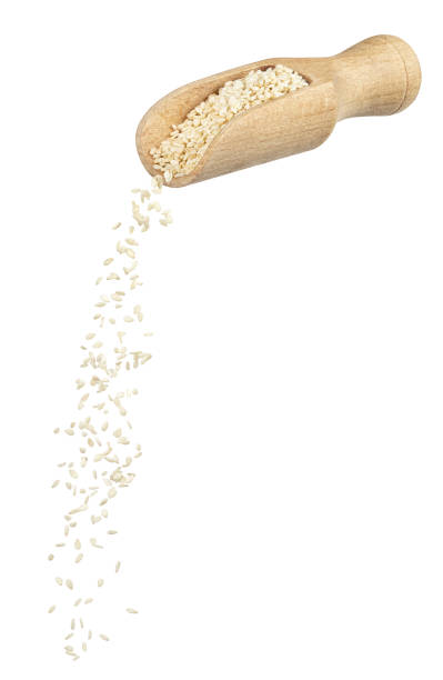 istock sesame seeds falling from wooden spoon isolated 1370432284