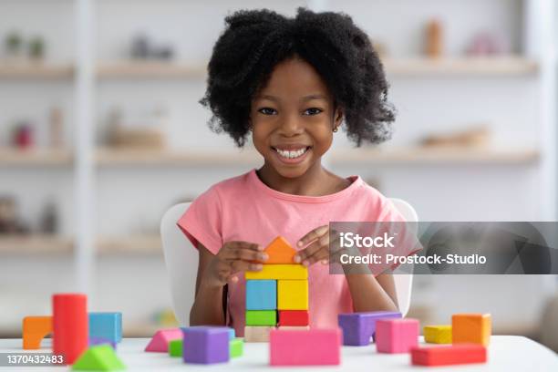 Happy Little Black Girl Playing With Colorful Wooden Blocks Stock Photo - Download Image Now