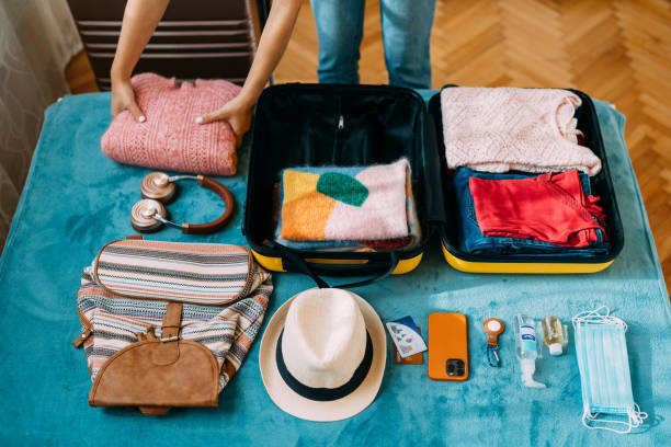 istock Woman packing suitcase for travel 1370432776
