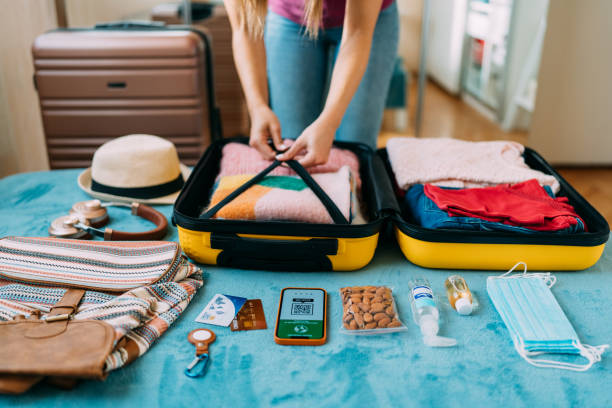 istock Woman packing suitcase for travel 1370432816
