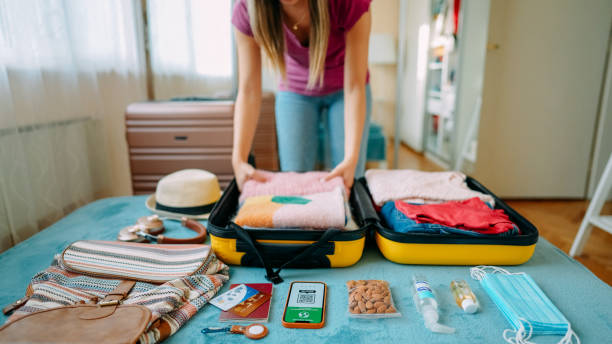istock Woman packing suitcase for travel 1370432837