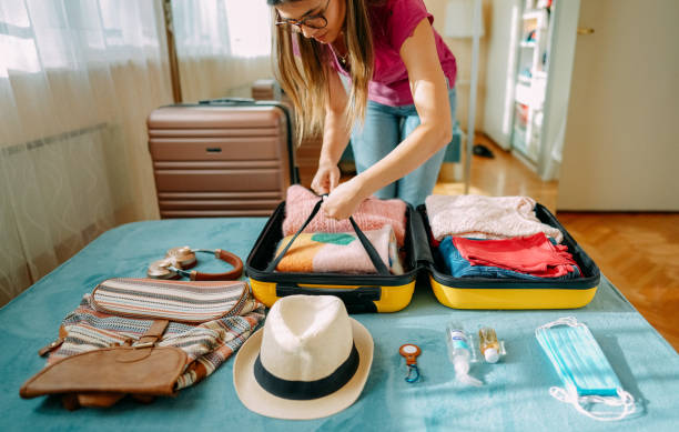 istock Woman packing suitcase for travel 1370432852