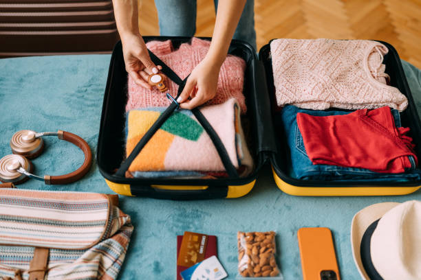 istock Woman packing suitcase for travel 1370432870