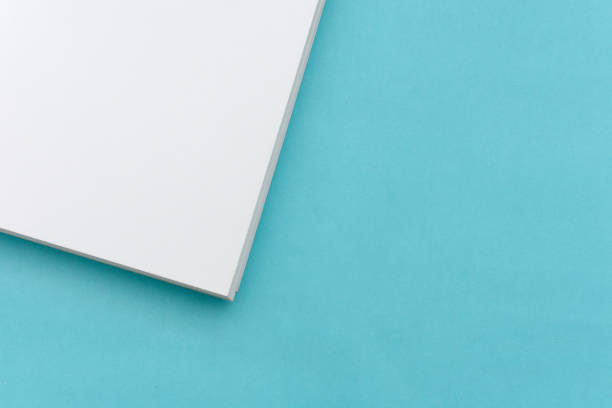 istock Sheets of paper on blue background. 1370435591