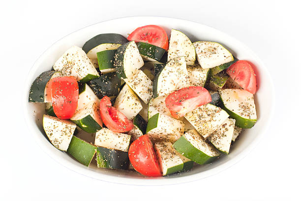 Sliced courgette and tomato ready for roasting stock photo