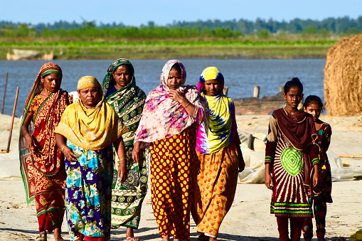 Rangpur, Bangladesh - September 18, 2017 Group of woman walking together around a river bank area