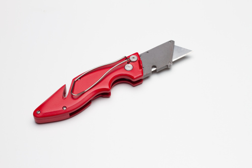 A red X-Acto knife that can be folded, with belt clip.