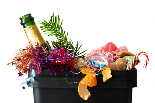 After christmas garbage dump food christmas tree branch empty bottle colorful tincel peel orange tangerine waste