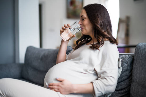 Pregnant woman at home stock photo