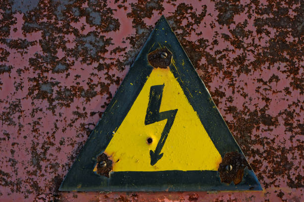 istock Old, rusty warning about danger and high voltage in form lightning yellow background. 1370448353