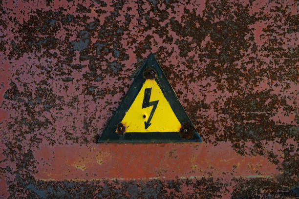 istock Old, rusty warning about danger and high voltage in form lightning yellow background. 1370448371