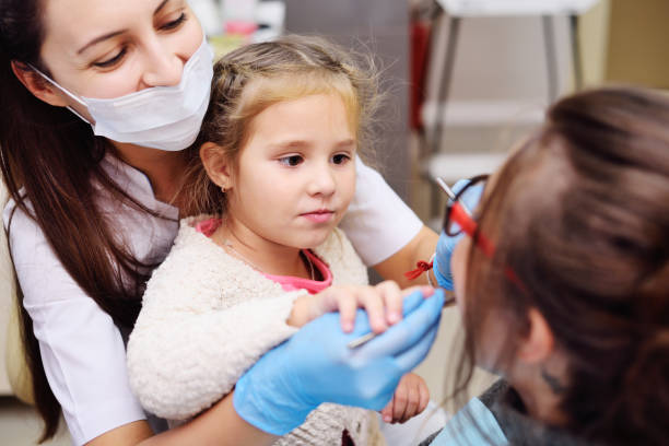istock baby helping a dentist examine a patient 1370449966