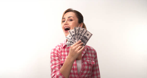 istock Young woman isolated on white background studio is holding USD in hand. 1370450106