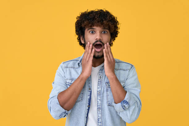 istock Shocked surprised young indian man isolated on yellow background. 1370451294