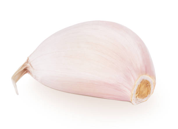 istock Fresh unpeeled garlic clove isolated on white background. 1370451574