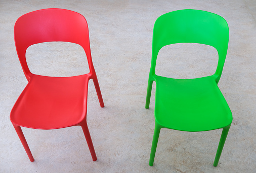 Overhead view of two colorful empty chairs for children in a classroom or other public space