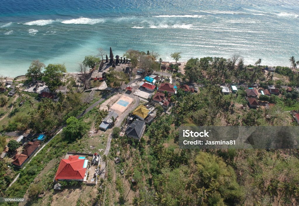 Small temple in village on Nusa Penida island, Kabupaten Klungkung, Bali, Indonesia Drone shot of a small temple in village on Nusa Penida island, Kabupaten Klungkung, Bali, Indonesia Aerial View Stock Photo