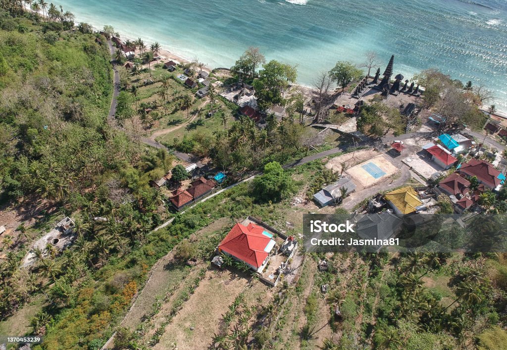 Small temple in village on Nusa Penida island, Kabupaten Klungkung, Bali, Indonesia Drone shot of a small temple in village on Nusa Penida island, Kabupaten Klungkung, Bali, Indonesia Aerial View Stock Photo