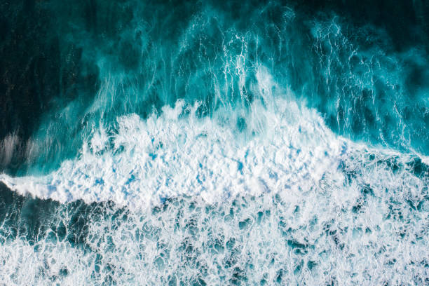 istock Big ocean waves hitting a coral reef. View from above. 1370454566