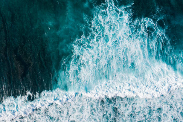 istock Big ocean waves hitting a coral reef. View from above. 1370454568