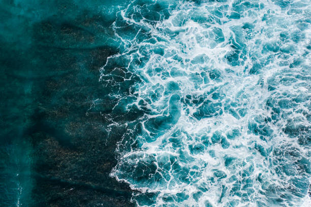 istock Big ocean waves hitting a coral reef. View from above. 1370454572