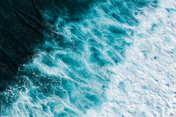 istock Big ocean waves hitting a coral reef. View from above. 1370454573