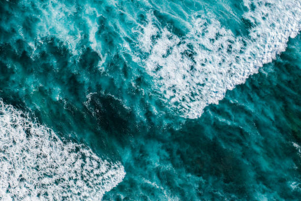 istock Big ocean waves hitting a coral reef. View from above. 1370454575
