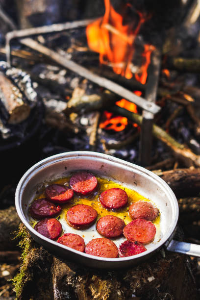 istock Cooking fresh  sausage on bushcraft stove 1370454599