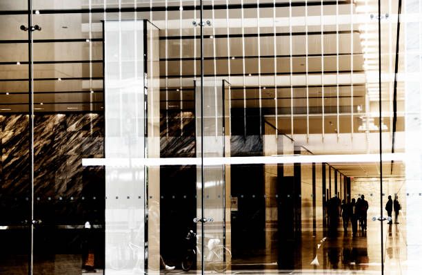 Businessmen in a contemporary architecture lobby,  Wall Street, Lower Manhattan, NYC.