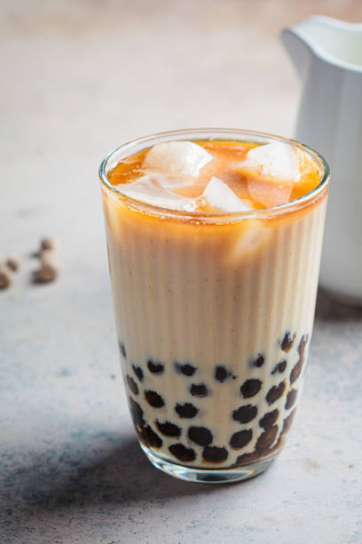 istock Milk bubble tea with tapioca pearls in glass, gray background. 1370454758