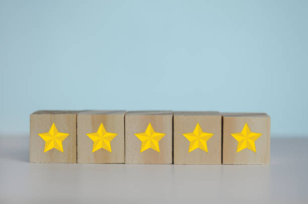 istock Wooden cubes with yellow star five symbol on background and copy space.Customer experience, satisfaction and best excellent services rating concepts. 1370455447