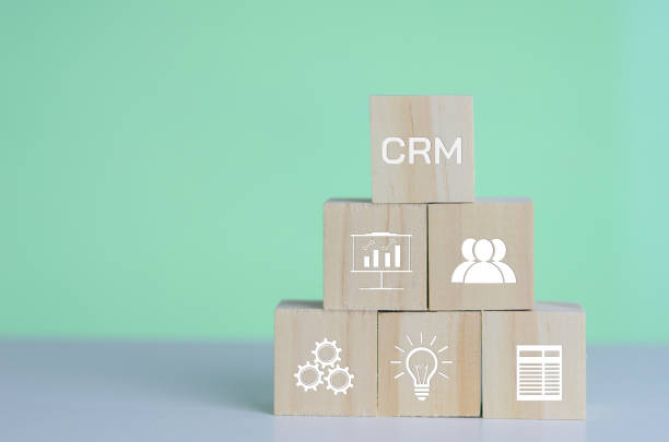 istock Wooden cubes with CRM  Customer relationship management automation system software symbol on background and copy space.Business concepts. 1370455453
