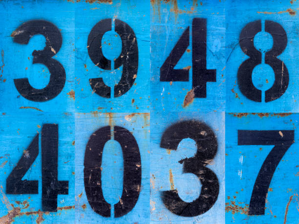 istock Numbers in black paint on an old blue iron surface with rust texture and traces of dirt. 1370456017