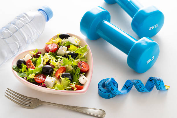 istock Weight loss concept: Exercising and healthy eating 1370457109