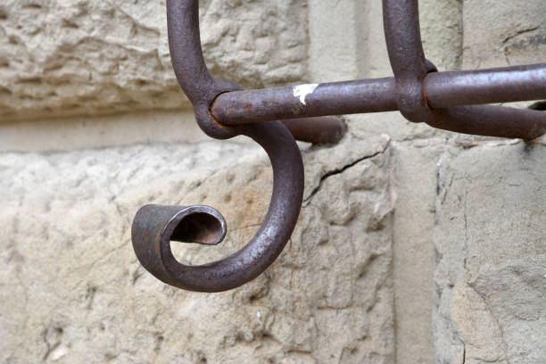 Bronze forged shelf with beautiful holders with scrolls and ornaments on the facade of a building