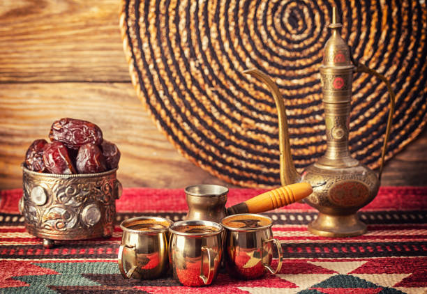istock Turkish coffee in a cezve and coffee cup set with dates on wooden background. 1370458768