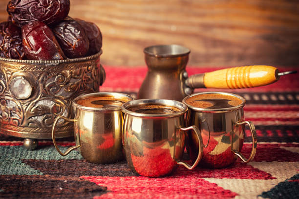 istock Turkish coffee in a cezve and coffee cup set with dates on wooden background. 1370458770