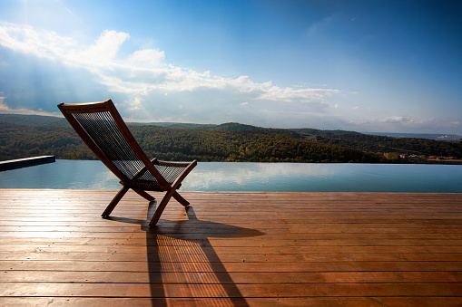 An open air villa with an infinity pool and a view looking out to the ocean during sunset in Acapulco Mexico.