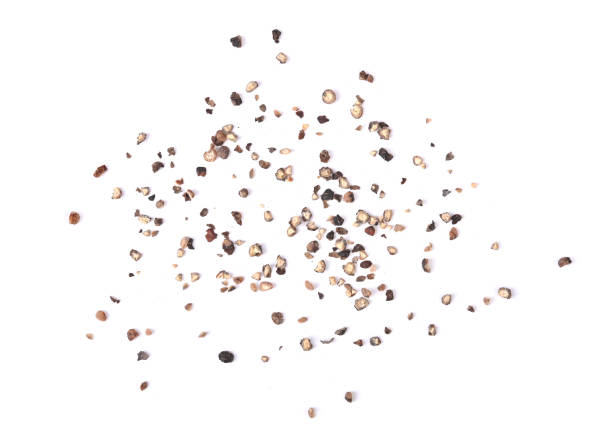 Ground black pepper isolated on a white background .Top view Coarsely ground black pepper isolated on a white background .Top view black peppercorn stock pictures, royalty-free photos & images