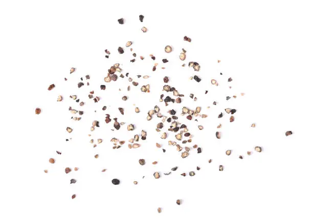 Coarsely ground black pepper isolated on a white background .Top view