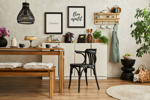 istock Stylish composition of cozy kitchen interior design with mock up poster frames, beige commode, wooden table, chair and bench and kitchen accessories. Template.